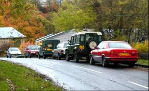 Several cars parked on a hill outside the Country Park centre
