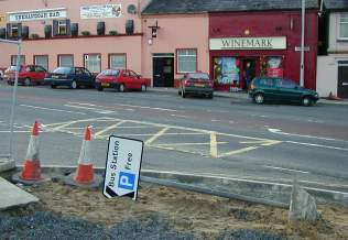 A bus station sign pointing south via the earth's core