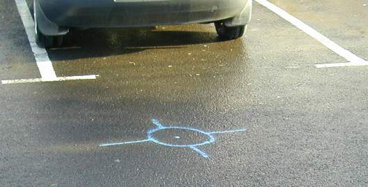 A strange symbol on the road of some kind.